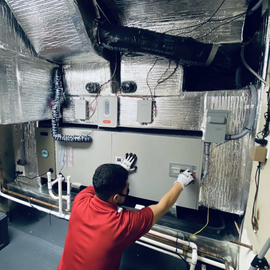 HVAC technician inspecting a system in Sacramento, CA
